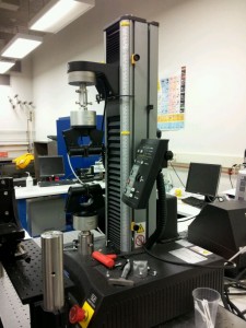 The tensile testing machine utilized to quantify the effectiveness of the artificial microstructures on the BMG to determine tensile ductility. Courtesy of Dr. Baran Sarac.