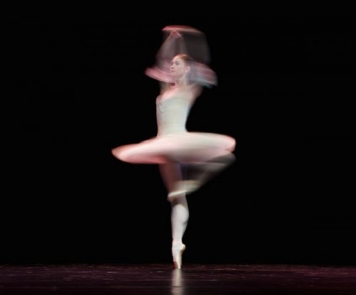 A ballerina spins rapidly in her execution of a pirouette. Courtesy of Leon Neal.