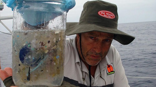 Captain Moore, posing with a water sample taken from the Great Garbage Patch. Courtesy of Algalita Marine Research Foundation.