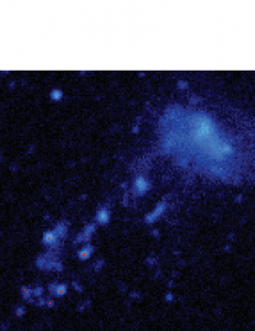 A Hydrogen-alpha (H-alpha) image of the dwarf galaxy IC3418. Blue ultraviolet emissions show the trail of gas that is ram-pressured stripped from the galaxy, and red is Hydrogen-alpha (H-alpha) emissions show bright knots of young stars forming in the tail of the galaxy. Courtesy of Jeffrey Kenney.