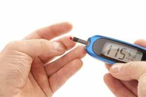 A blood glucose meter being used to test a sample of blood. Reading between 140 and 199 mg/dL indicate glucose intolerance (pre-diabetes) and readings above 200 mg/dL indicate diabetes (type 1 or 2). Image courtesy of completehealthnews.com