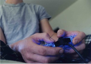 A tuned-in gamer grips his controller with intense concentration. Image courtesy of Wikimedia.