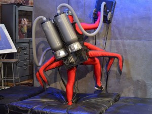 Host Seth Herzog dons a vacuum cleaner backpack and a man-spider costume before climbing a 15 foot wall to show the power of suction and air pressure. Image courtesy of National Geographic Channel/ Michael Negri.