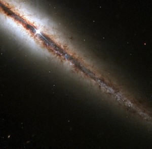 Brownish-red interstellar dust can be seen in this spiral galaxy. Note how the presence of dust blocks the light of any objects that could be present in the background. Image courtesy of Flickr.
