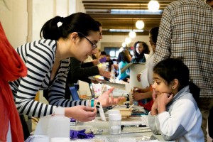 An undergraduate volunteer explains how different components of pigments can be chemically separated. Photo by Suryabrata Dutta.