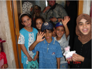 While on duty in Iraq, Ferry delivered supplies to the Al Amal Institute for Deaf Children, among serving other roles as a military physician. Image courtesy of Robert Ferry, Jr.