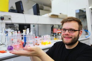 Dr. Sørensen with a collection of dyes that resemble the molecular building blocks used to make ordered nanomaterials and oriented thin films. (Image Courtesy of Jes Andersen/University of Copenhagen)