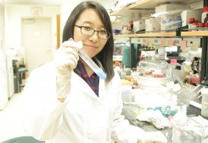 Hee Won Suh, a postdoctoral fellow in biomedical engineering, prepares a nanoparticle solution in the Saltzman Lab. Image courtesy of Andrea Ouyang